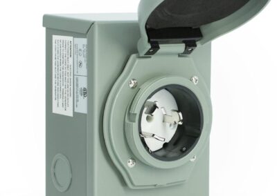 A gray outdoor electrical outlet box with a circular plug-in socket and hinged cover, shown open.